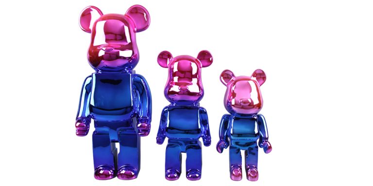 Three colorful metal bear - shaped sculptures of different sizes